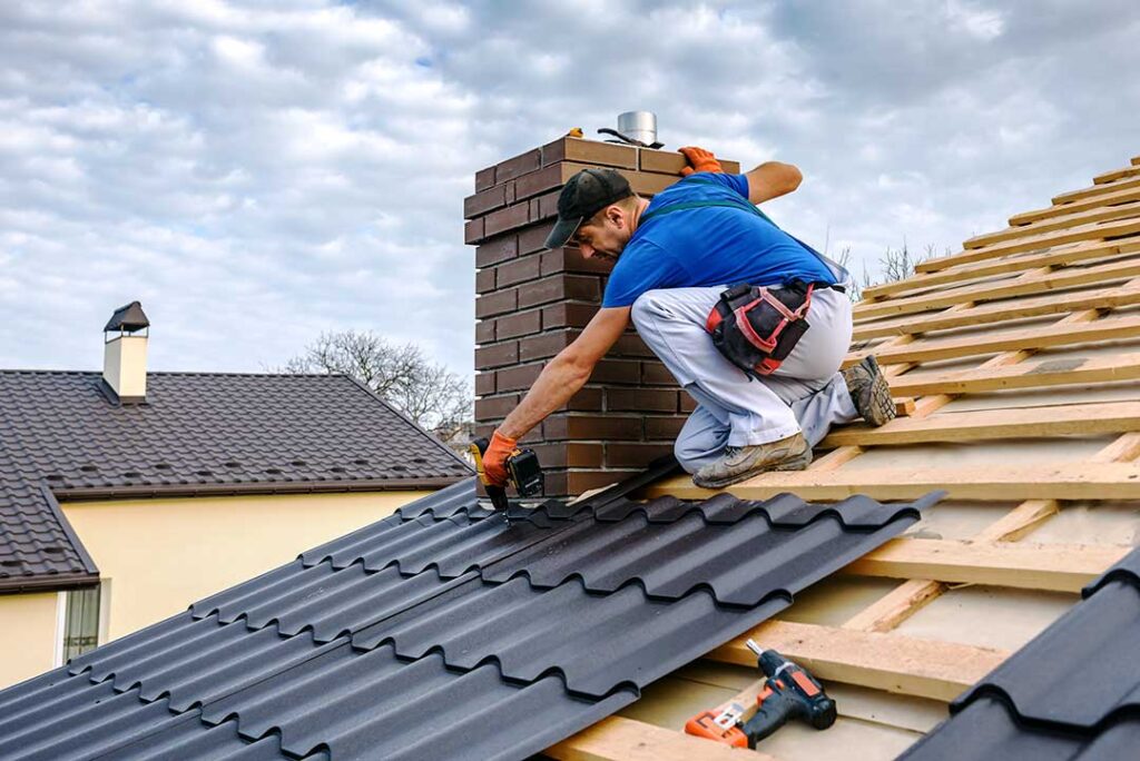 An attic with visible roof framing, soffit vents, insulation, and sunlight entering through a ridge vent.